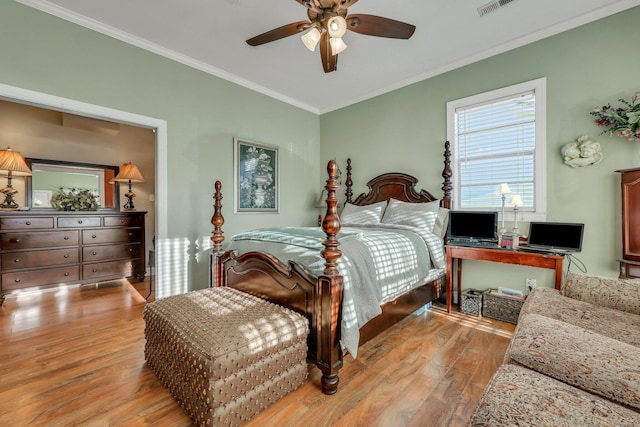 bedroom featuring ceiling fan, light hardwood / wood-style flooring, and crown molding