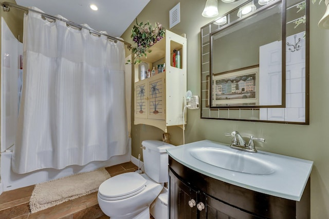 full bathroom with tile patterned floors, shower / tub combo with curtain, vanity, and toilet