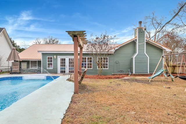 back of house with a yard and french doors