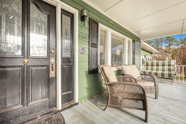 property entrance with covered porch