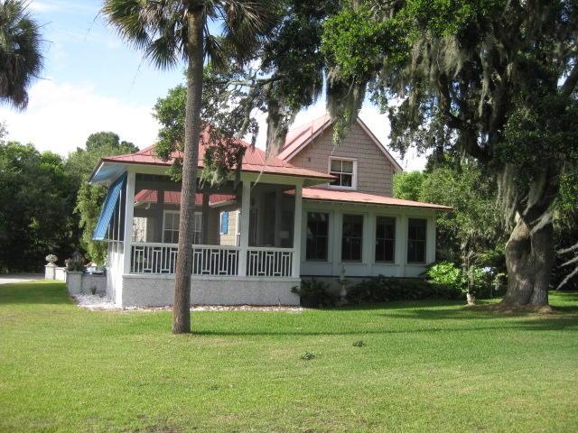 back of property with a lawn