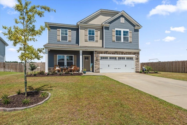 craftsman-style house with a garage and a front lawn