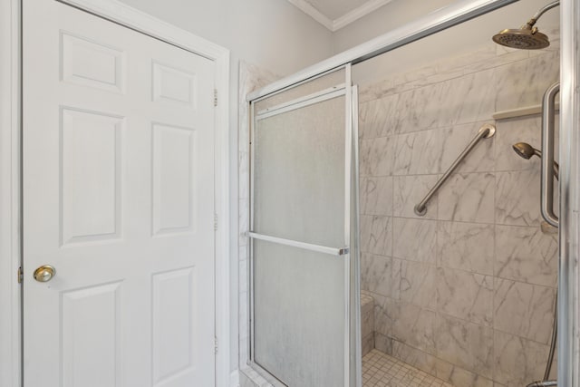 bathroom with a shower stall and ornamental molding