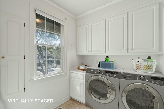 washroom with ornamental molding, baseboards, cabinet space, and washing machine and clothes dryer