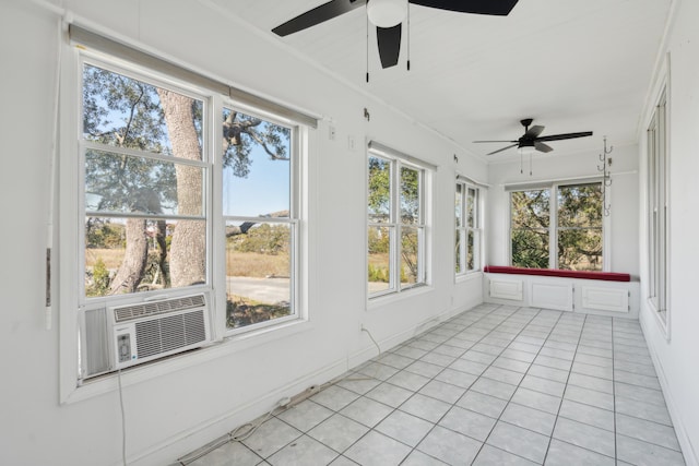 unfurnished sunroom featuring cooling unit and a ceiling fan