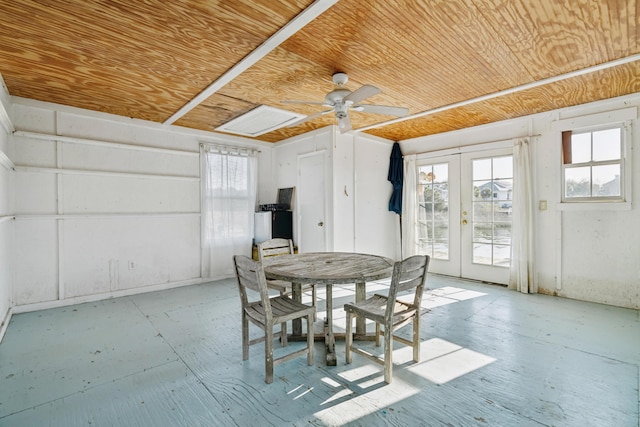 dining space with a ceiling fan, french doors, and wooden ceiling