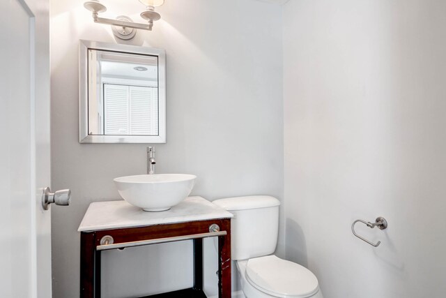 bathroom featuring toilet and vanity