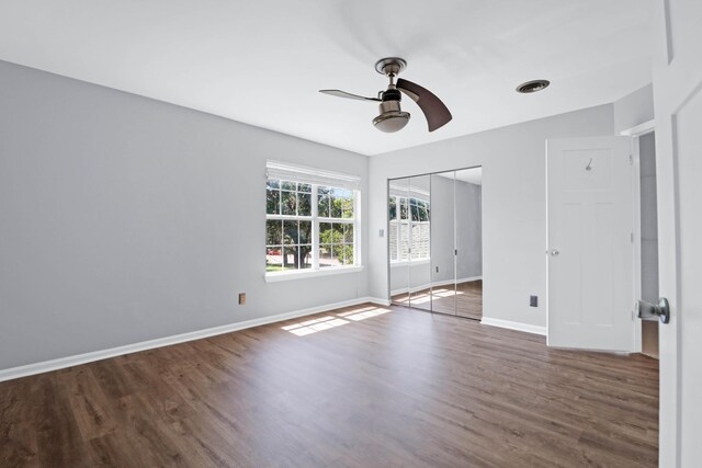 spare room with ceiling fan and dark wood-type flooring