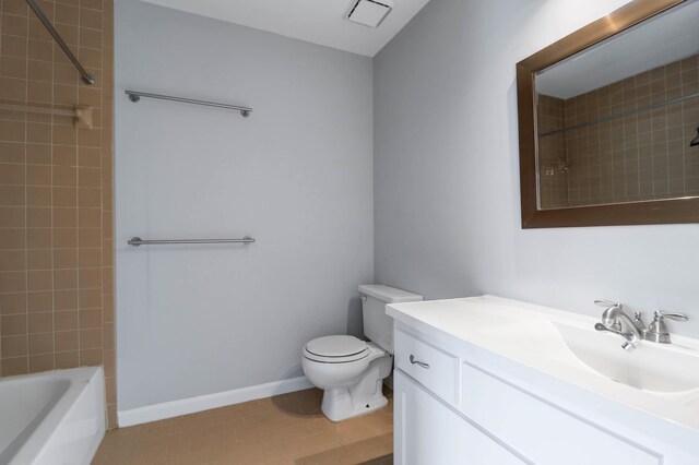 full bathroom with tiled shower / bath combo, tile patterned flooring, toilet, and vanity