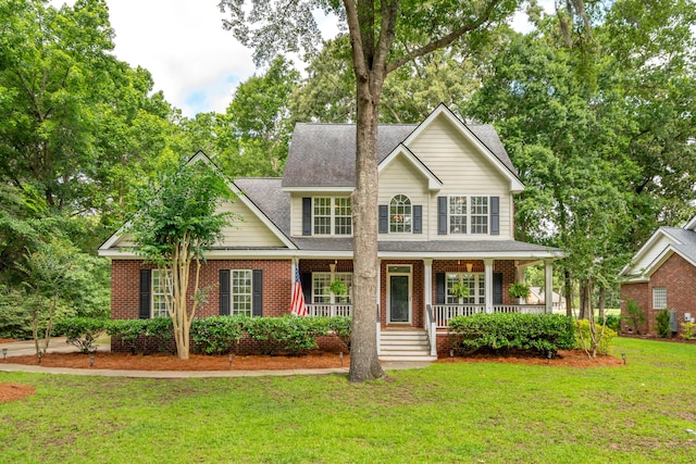 5195 Forest Oaks Dr, Hollywood, SC 29449 - view of front of home featuring a front lawn, a porch, brick siding, and roof with shingles