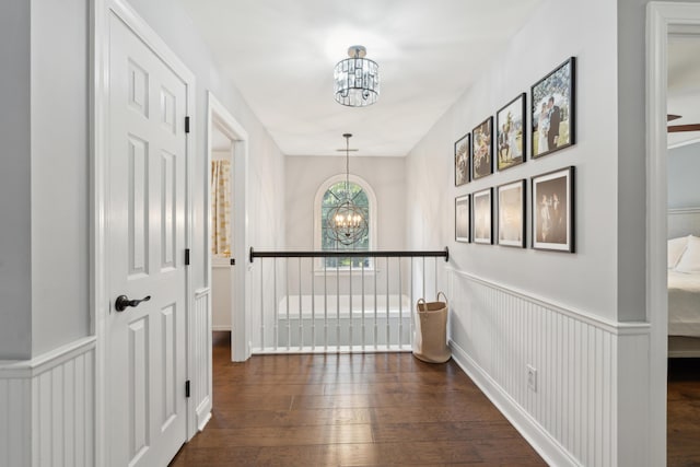 5195 Forest Oaks Dr, Hollywood, SC 29449 - hallway featuring a chandelier, wood-type flooring, and a wainscoted wall