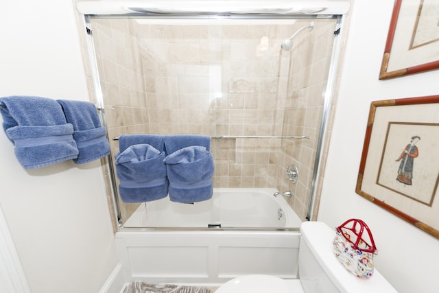 bathroom featuring toilet and enclosed tub / shower combo