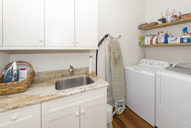 washroom with cabinets, sink, and washing machine and dryer