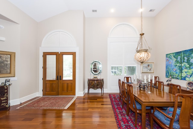 entryway featuring high vaulted ceiling, hardwood / wood-style floors, an inviting chandelier, and french doors