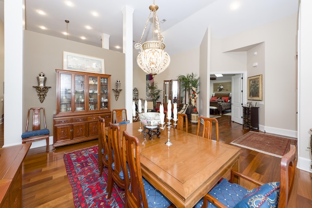 dining room with hardwood / wood-style floors and an inviting chandelier