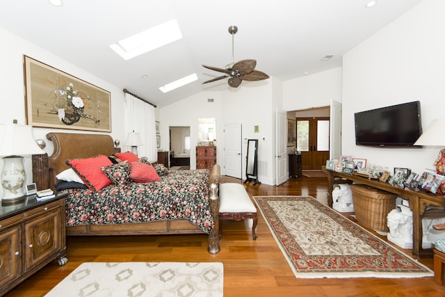 bedroom with a skylight, high vaulted ceiling, ceiling fan, and hardwood / wood-style floors