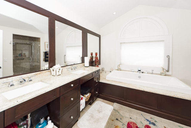 bathroom featuring tile flooring, dual sinks, oversized vanity, lofted ceiling, and plus walk in shower