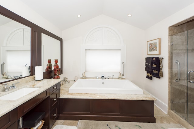 bathroom featuring tile flooring, vanity, vaulted ceiling, and plus walk in shower