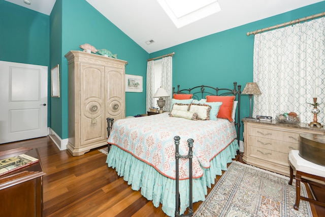 bedroom featuring a skylight, high vaulted ceiling, dark hardwood / wood-style floors, and multiple windows