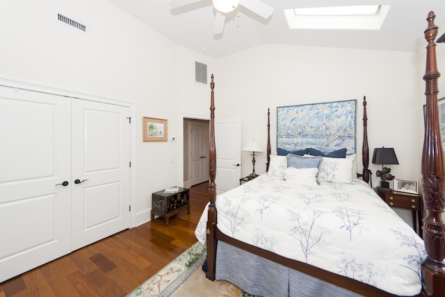 bedroom with lofted ceiling with skylight, ceiling fan, light hardwood / wood-style floors, and a closet