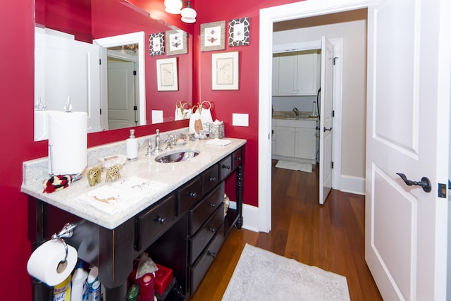 bathroom with hardwood / wood-style floors and vanity