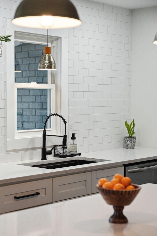 kitchen with sink, stainless steel dishwasher, and decorative backsplash