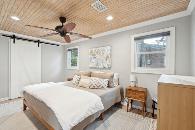 bedroom with ceiling fan, a barn door, light hardwood / wood-style flooring, and wood ceiling