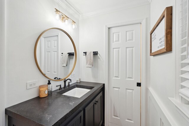 bathroom featuring ornamental molding and vanity