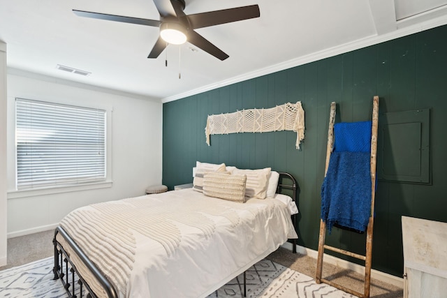 bedroom with ceiling fan, ornamental molding, and light colored carpet