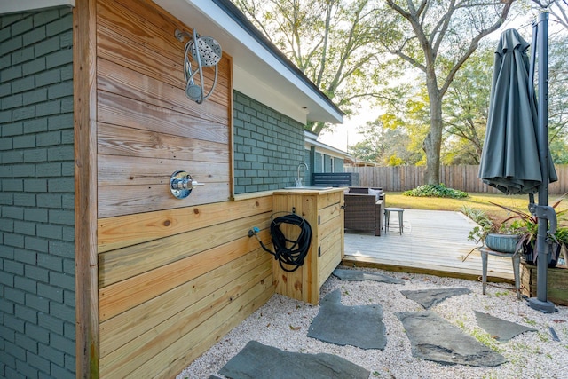 view of patio featuring a wooden deck and sink