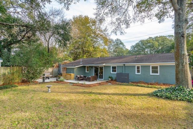 back of house featuring a patio, an outdoor living space, and a lawn