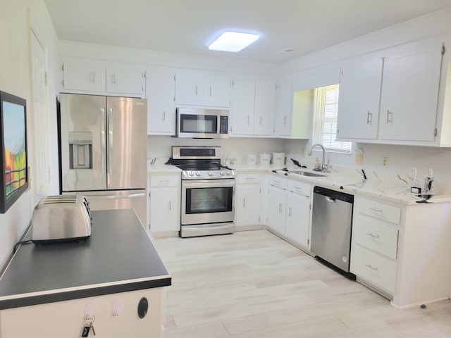 4457 Rice Mill Dr, North Charleston, SC 29420 - kitchen with appliances with stainless steel finishes, white cabinets, and light wood-style floors