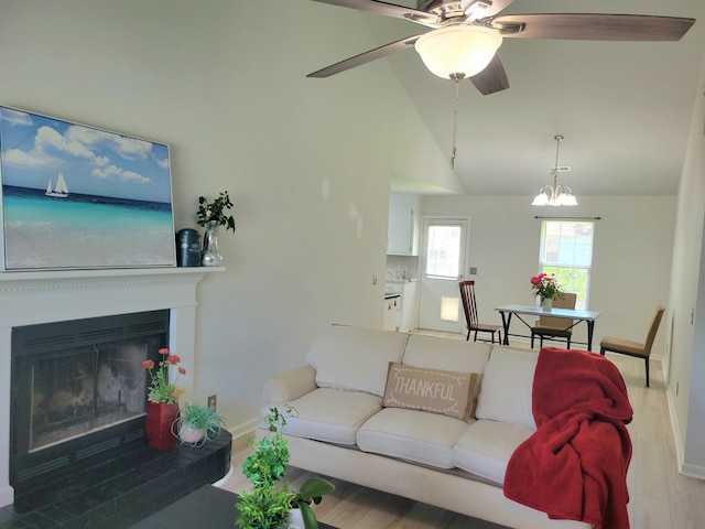 4457 Rice Mill Dr, North Charleston, SC 29420 - living area with a ceiling fan, high vaulted ceiling, a glass covered fireplace, and a chandelier