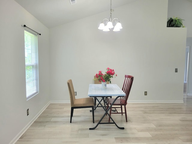 4457 Rice Mill Dr, North Charleston, SC 29420 - dining area with a chandelier, light wood-style floors, and lofted ceiling