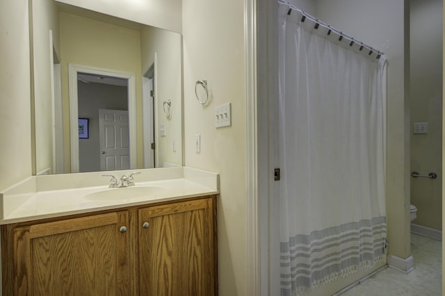 bathroom with vanity, walk in shower, and toilet