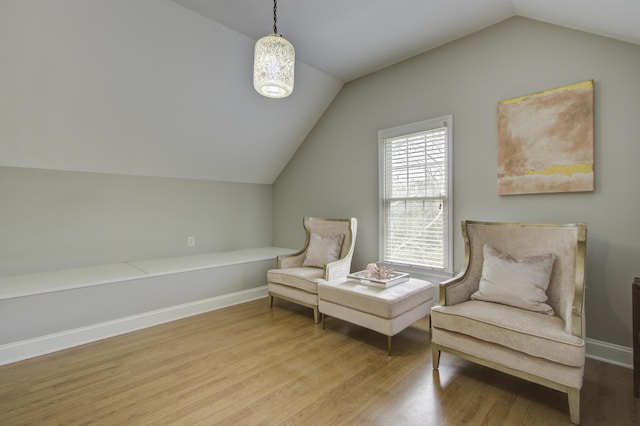 living area with hardwood / wood-style flooring and vaulted ceiling