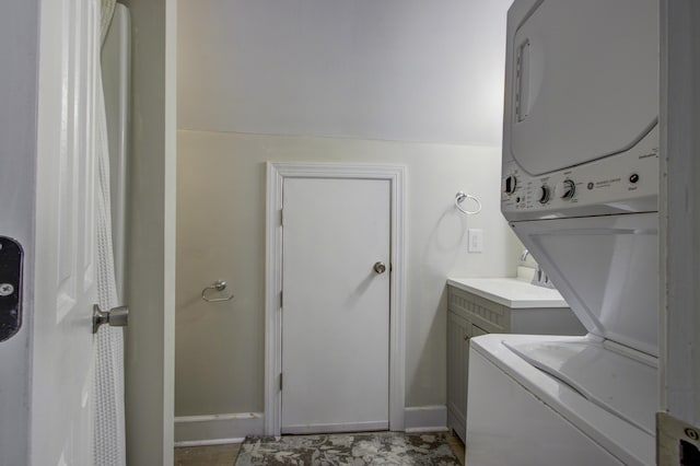 clothes washing area with stacked washer / drying machine