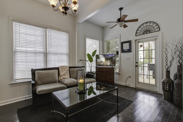 living room featuring dark hardwood / wood-style floors, ceiling fan with notable chandelier, and beam ceiling