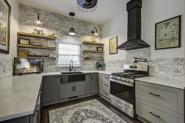 kitchen with gray cabinets, extractor fan, pendant lighting, sink, and gas range