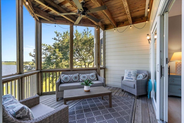 sunroom with ceiling fan, beam ceiling, a water view, and wood ceiling