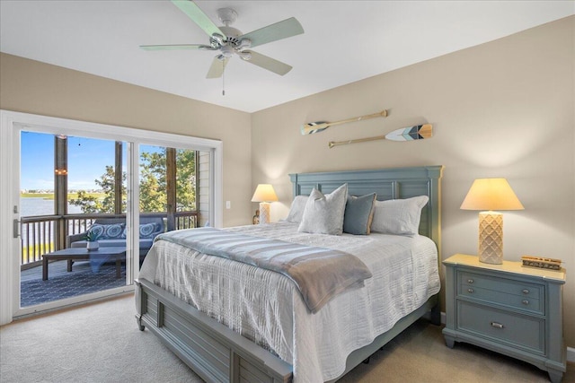 carpeted bedroom with access to outside, ceiling fan, and a water view