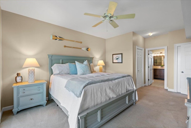 carpeted bedroom featuring connected bathroom and ceiling fan