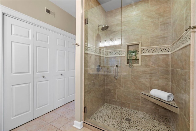 bathroom featuring tile patterned flooring and a shower with door