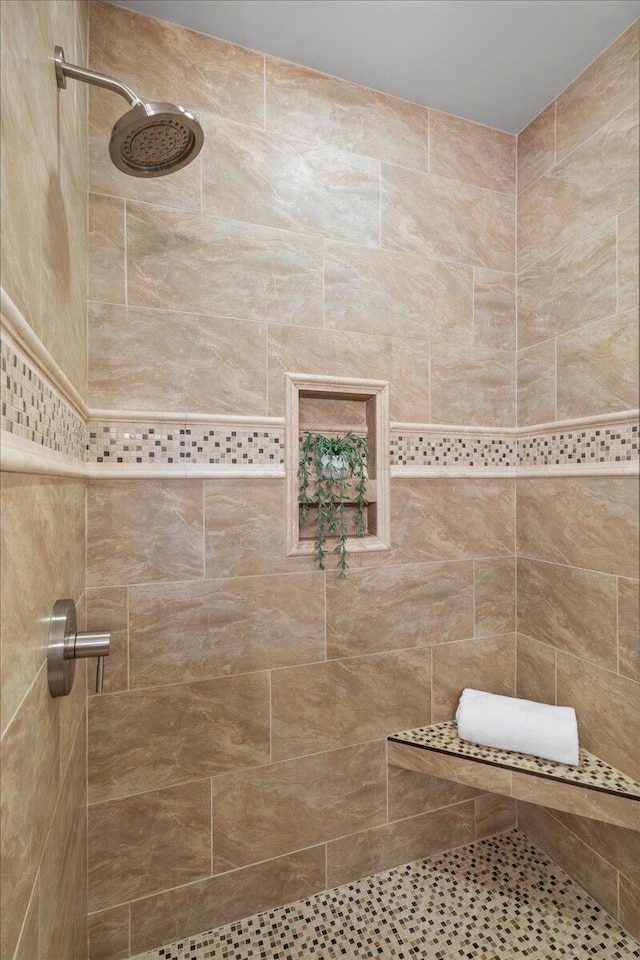 bathroom with a tile shower