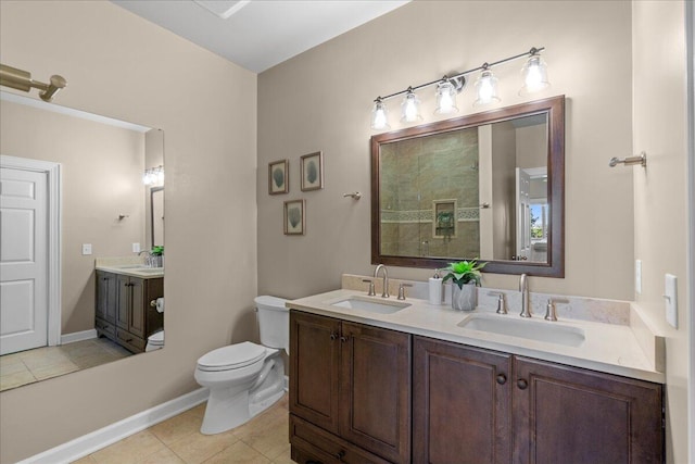 bathroom featuring tile patterned floors, vanity, and toilet