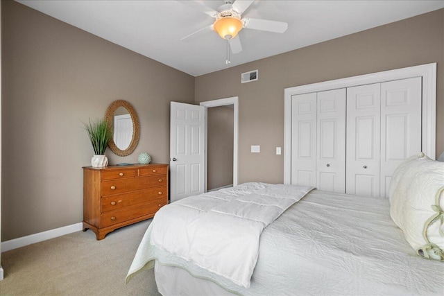 carpeted bedroom featuring ceiling fan and a closet