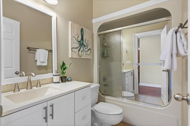 full bathroom featuring vanity, enclosed tub / shower combo, and toilet