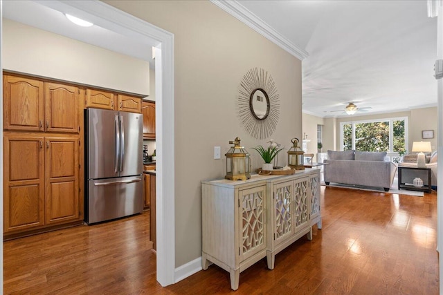 corridor featuring hardwood / wood-style floors and crown molding