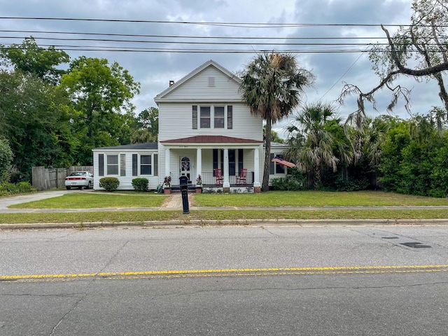 view of front facade with a porch and a front lawn