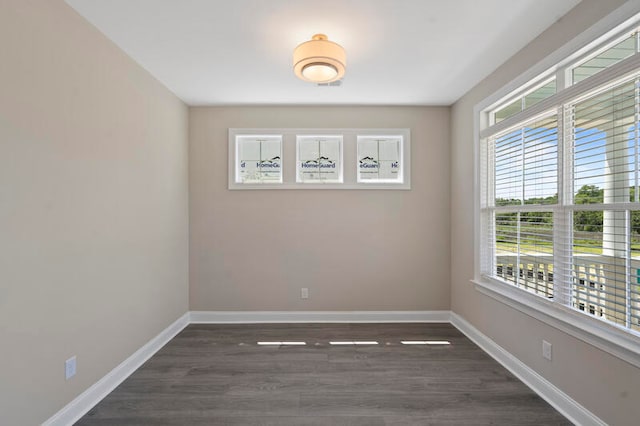 unfurnished room featuring wood finished floors and baseboards